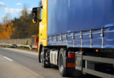 a commercial vehicle driving along the highway