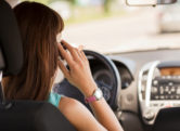 a woman driving while talking on the phone