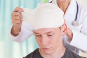 brain injured boy with bandages
