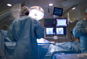 cardiologist implanting defibrillator