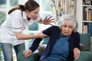 Caregiver mistreating senior citizen woman