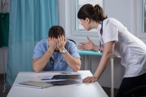 Frustrated doctor talking to nurse.