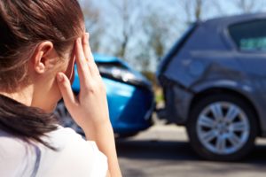 a woman looking at a car accident scene