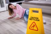 Woman falling on wet floor.