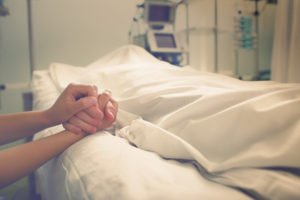 Holding the hand of a family member after a wrongful death