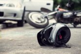 Motorcycle driver fell his helmet on the road on road accident.