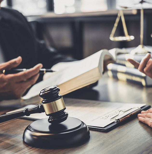 Photograph of two peoples hands in the act of talking surrounded by books and legal symbols